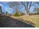 Landscaped backyard with mature trees and open space at 4386 Bluebird Ln, Lithia Springs, GA 30122
