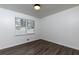 Well-lit bedroom with hardwood floors and a window at 4706 Lincoln Sw Way, Lilburn, GA 30047