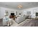 Spacious living room featuring comfortable seating, built-in shelving, and hardwood floors at 4706 Lincoln Sw Way, Lilburn, GA 30047