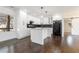 Modern white kitchen with island, dark hardwood floors, and stainless steel appliances at 1863 Bruce Ne Rd, Atlanta, GA 30329