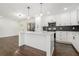 White kitchen with island, dark hardwood floors, and stainless steel appliances at 1863 Bruce Ne Rd, Atlanta, GA 30329