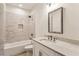 Bathroom with subway tile shower, white vanity, and quartz countertop at 1926 Fairway Ne Cir, Brookhaven, GA 30319