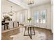 Light-filled entryway with hardwood floors, a cowhide rug, and views to dining area at 1926 Fairway Ne Cir, Brookhaven, GA 30319