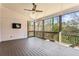 Spacious screened porch with wood decking, ceiling fan, and TV mount at 1926 Fairway Ne Cir, Brookhaven, GA 30319