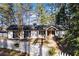 White house with black shutters, stone accents, and a white picket fence, aerial view at 2529 Piney Grove Rd, Loganville, GA 30052