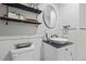 Clean bathroom with a pedestal sink and floating shelves at 2529 Piney Grove Rd, Loganville, GA 30052