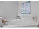 Bathroom with a corner soaking tub and decorative accents at 2529 Piney Grove Rd, Loganville, GA 30052