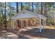 White carport with a gabled roof and concrete flooring at 2529 Piney Grove Rd, Loganville, GA 30052