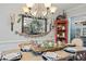 Bright dining room features a rustic farmhouse table, chandelier, and built-in shelving at 2529 Piney Grove Rd, Loganville, GA 30052