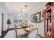 Bright dining room with a wooden table, chandelier, and access to the backyard at 2529 Piney Grove Rd, Loganville, GA 30052