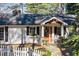 Charming white house with black shutters, stone accents and a white picket fence at 2529 Piney Grove Rd, Loganville, GA 30052