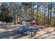 Outdoor fire pit with chairs, near sheds and trees at 2529 Piney Grove Rd, Loganville, GA 30052