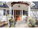 Inviting front porch with stone pillars, wooden ceiling beams, and a charming bench at 2529 Piney Grove Rd, Loganville, GA 30052