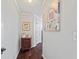 Home hallway with hardwood floors, neutral walls, and decorative side table at 2529 Piney Grove Rd, Loganville, GA 30052