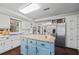 Modern kitchen with white cabinets, granite island, and stainless steel refrigerator at 2529 Piney Grove Rd, Loganville, GA 30052