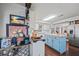 Open kitchen with light blue island, stainless steel appliances, and hardwood floors at 2529 Piney Grove Rd, Loganville, GA 30052