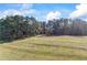 Open lot with distant home and shed at 2529 Piney Grove Rd, Loganville, GA 30052