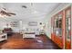 Sunlit living room with hardwood floors, a view and comfortable seating at 2529 Piney Grove Rd, Loganville, GA 30052