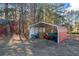 Red and white metal storage shed with supplies inside at 2529 Piney Grove Rd, Loganville, GA 30052