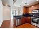 Modern kitchen with dark wood cabinets and stainless steel appliances at 3324 Peachtree Ne Rd # 1510, Atlanta, GA 30326