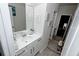 Bright bathroom with white cabinets, drawers, a sink, and a large mirror at 3227 Hidden Valley Cir, Lawrenceville, GA 30044