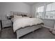 Comfortable bedroom featuring a luxurious bed and a bedside table with a lamp at 3227 Hidden Valley Cir, Lawrenceville, GA 30044