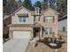 Two-story brick home with a landscaped yard and attached garage at 3227 Hidden Valley Cir, Lawrenceville, GA 30044