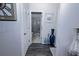 Hallway with hardwood floors, white doors, and view into a bathroom with glass shower at 3227 Hidden Valley Cir, Lawrenceville, GA 30044