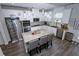 Modern kitchen featuring stainless steel appliances, granite countertops, a kitchen island, and a stylish backsplash at 3227 Hidden Valley Cir, Lawrenceville, GA 30044