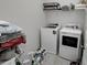 Laundry room featuring modern appliances and ample storage space on a rack at 3227 Hidden Valley Cir, Lawrenceville, GA 30044