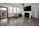 Bright living room boasts hardwood floors, a fireplace, large windows, and modern decor at 3227 Hidden Valley Cir, Lawrenceville, GA 30044