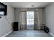 Spare bedroom with wood-look floors, large window, neutral walls, and shoe rack at 861 Chandler Rd, Lawrenceville, GA 30045