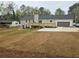 Renovated home's back exterior featuring a new deck, patio, and an expansive yard at 1320 Melbenan Dr, Atlanta, GA 30311