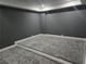Finished basement with gray carpet, wainscotting, and moody gray walls at 1320 Melbenan Dr, Atlanta, GA 30311