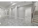 Finished basement with polished marble floor, access to stairs, and a doorway to another room at 1320 Melbenan Dr, Atlanta, GA 30311