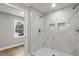 Stylish bathroom with marble shower, glass door, and modern fixtures at 1320 Melbenan Dr, Atlanta, GA 30311