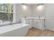 Modern bathroom with soaking tub, double vanity, and recessed lighting at 1320 Melbenan Dr, Atlanta, GA 30311