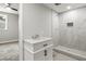 Bathroom with white marble tiled shower, modern vanity, and neutral paint, all exuding elegance and style at 1320 Melbenan Dr, Atlanta, GA 30311