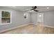 An airy bedroom is shown with hardwood floors, recessed lights, and an attached bathroom at 1320 Melbenan Dr, Atlanta, GA 30311