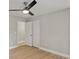 A neutral bedroom is shown with a ceiling fan and hardwood flooring and two white doors at 1320 Melbenan Dr, Atlanta, GA 30311