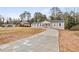 Charming home with a sprawling driveway and beautifully maintained front yard at 1320 Melbenan Dr, Atlanta, GA 30311