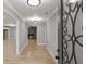 Hallway with hardwood floors leading to a living room with a fireplace at 1320 Melbenan Dr, Atlanta, GA 30311