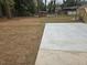 Newly poured concrete patio, surrounded by a large, flat backyard space at 1320 Melbenan Dr, Atlanta, GA 30311