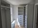 Spacious walk-in closet featuring built-in shelves, drawers, and hanging rods, providing ample storage solutions at 1320 Melbenan Dr, Atlanta, GA 30311