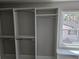 Bright walk-in closet with ample hanging space, open shelving, and a window seat for added convenience at 1320 Melbenan Dr, Atlanta, GA 30311