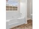 Bathroom with a soaking tub under a window and separate shower at 2916 Ward Lake Way, Ellenwood, GA 30294