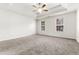 Spacious bedroom with a tray ceiling, ceiling fan, and two bright windows at 2916 Ward Lake Way, Ellenwood, GA 30294