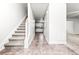 Bright entryway with tile floors, staircase, and view into the kitchen at 2916 Ward Lake Way, Ellenwood, GA 30294