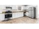 Modern kitchen with stainless steel appliances, granite countertops, and tile flooring at 2916 Ward Lake Way, Ellenwood, GA 30294