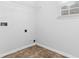 Clean laundry room featuring white walls, tile floors, and a window at 2916 Ward Lake Way, Ellenwood, GA 30294